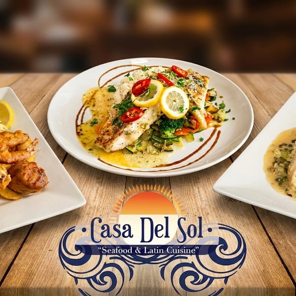 Three plates of Casa Del Sol's seafood and Latin cuisine, including fish and chips, on a wooden table.